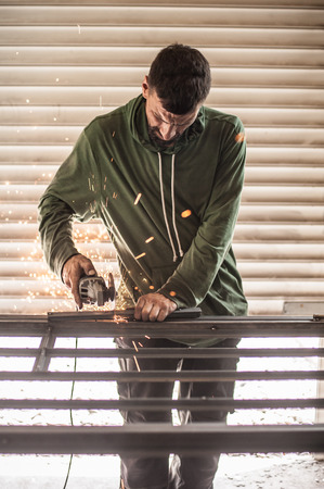 Electric wheel grinding on steel structure in factory. Sparks from the grinding wheelの写真素材