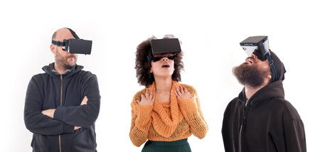 Group of people having fun with virtual reality glasses. Studio shoot