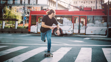 Professional skater riding skate on the main streets through cars and heavy trafficの写真素材