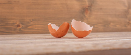 Close up of broken eggshell on rustic wooden table