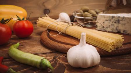 Food ingredients for preparing pasta on wooden kitchen board. Vegetables, saucesの写真素材