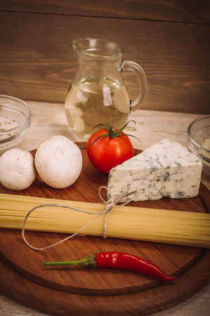 Food ingredients for preparing pasta on wooden kitchen board. Vegetables, saucesの写真素材