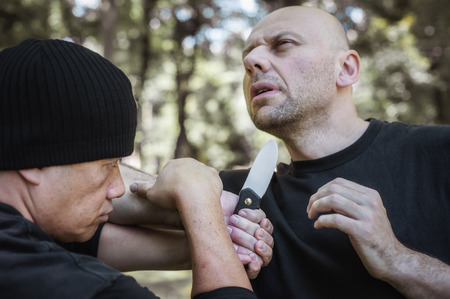 Lameco Astig Combatives instructor demonstrates martial arts self defense fighting and disarming technique. Filipino Martial Arts. Ecrima, Kali, Arnisの写真素材