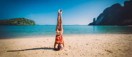 Fit woman relaxing and practicing yoga outdoors by the sea. Relax and meditate concept