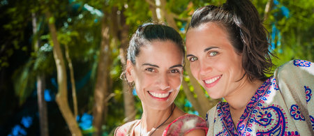 Portraits of two happy girlfriends smiling and enjoying on the beach