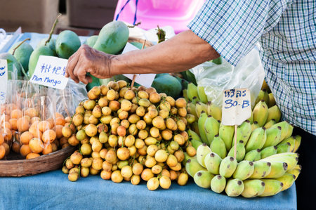CHIANG MAI, THAILAND - 06. MAY 2018. An unidentified Asian vendor selling tropical, exotic fresh fruit on the street. Day editorial shotのeditorial素材