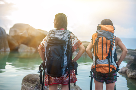 Two girlfriends with backpack enjoying on summer vacation. Tourism and vacation conceptの写真素材