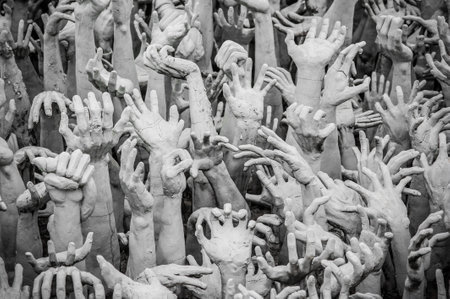 WAT RONG KHUN - WHITE TEMPLE, CHIANG RAI THAILAND - CIRCA MAY 2018. The sculpture of hundreds outreaching hands that symbolize unrestrained desire.のeditorial素材
