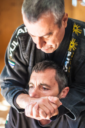 BELGRADE, SERBIA - 05. OCTOBER 2018. Kapap instructor Avi Nardia demonstrate choke technique. KAPAP SELF DEFENSE SEMINARのeditorial素材
