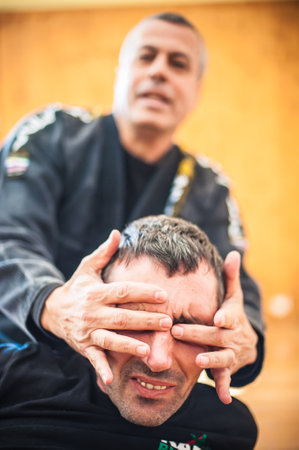 BELGRADE, SERBIA - 05. OCTOBER 2018. Kapap instructor Avi Nardia shows the critical and highly sensitive points on the human body. Pressure points fighting concept. KAPAP SELF DEFENSE SEMINARのeditorial素材