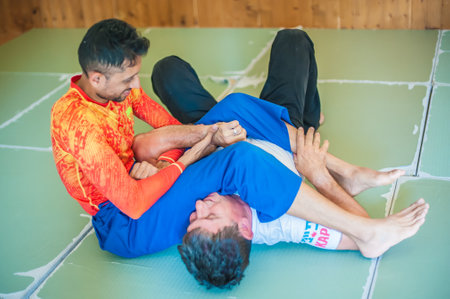BELGRADE, SERBIA â 04 -12. OCTOBER 2018. Instructor and Students practice BJJ Brazilian jiu-jitsu technique training on the AVI NARDIA KAPAP SELF DEFENSE SEMINARのeditorial素材