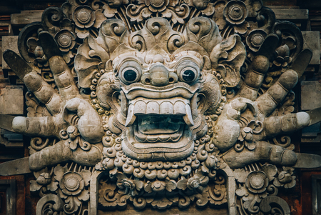 Closeup portrait of stone traditional sculpture art form incorporated into temples, which demonstrate the influences of Hindu Buddhist culture. Bali, Indonesiaの写真素材
