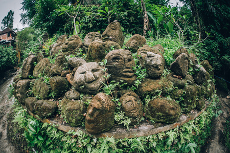 Closeup portrait of stone traditional sculpture art form incorporated into temples, which demonstrate the influences of Hindu Buddhist culture. Bali, Indonesiaの写真素材