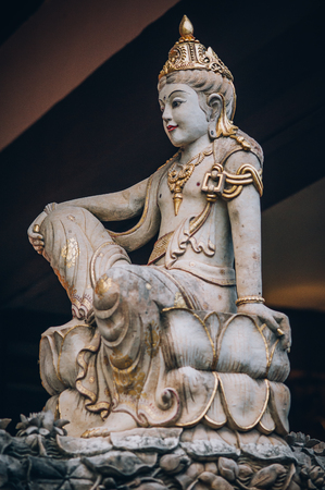 Closeup portrait of stone traditional sculpture art form incorporated into temples, which demonstrate the influences of Hindu Buddhist culture. Bali, Indonesiaの写真素材