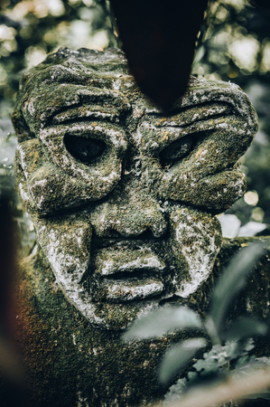Closeup portrait of stone traditional sculpture art form incorporated into temples, which demonstrate the influences of Hindu Buddhist culture. Bali, Indonesiaの写真素材