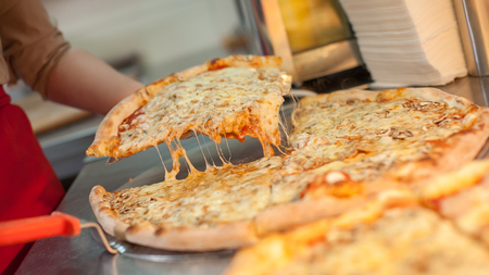 Slice of margarita pizza on scapula. Tasty fast food italian traditionalの写真素材