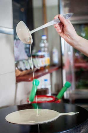 Crepe pancakes are handmade crepes on a hot metal grill. Tasty crepe dessertの写真素材