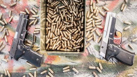 Top view of gun and ammunition box on the table. Bullets for pistol in shooting rangeの写真素材