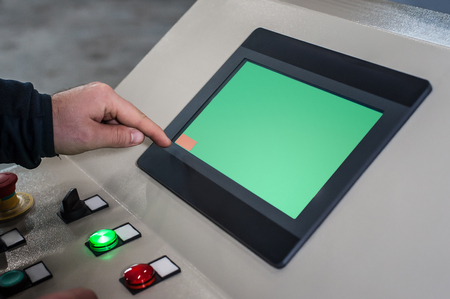 Industrial machinery mechanics and factory worker adjusts industry machine and checks if everything works properlyの写真素材