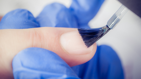 Finger nail treatment, grinding and polishing in beauty salon. Manicure processの写真素材