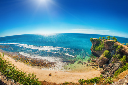 Idyllic tropical beach, palm, white sand and crystal clear water. Amazing beach. Landscape for background or wallpaper. Uluwatu, Bali, Indonesiaの写真素材