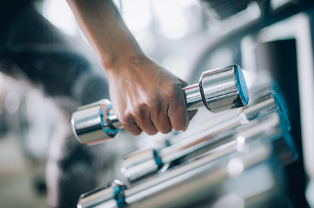Close up of dumbbells in woman hand. Power fitness, sport, training, lifestyleの写真素材