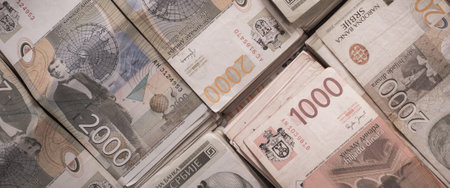 BELGRADE, SERBIA â€“ 9. SEPTEMBER 2019. Different money bills stacked over each other forming a...