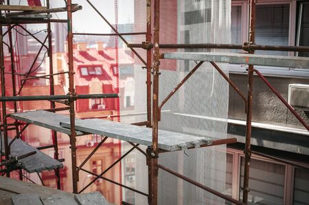 Safety scaffolding in the construction site. Building renovation process. Close upの写真素材