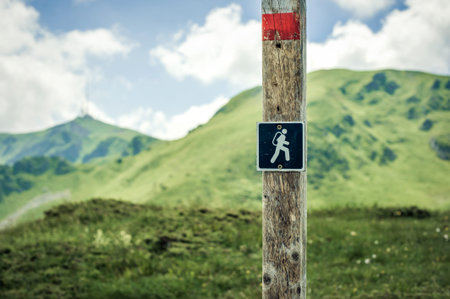 Hiking sign. Road sign board on the mountain. Adventure outdoor. Peak mountain background