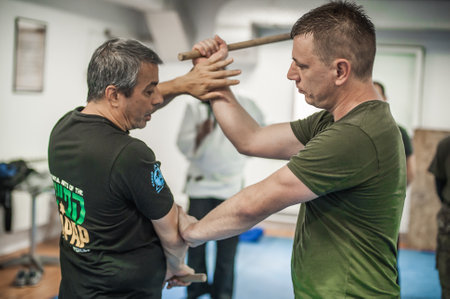 BELGRADE, SERBIA - 13. OCTOBER 2019. Kapap Krav Maga Sensei master instructor Avi Nardia demonstrates combat knife attack self-defense technique to large group of students on Kapap Krav Maga seminarのeditorial素材