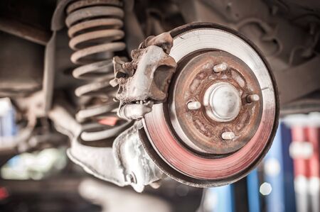 Motor vehicle on lift in auto vulcanizing and service workshop. Close upの写真素材