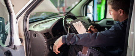 Automobile computer diagnosis. Car mechanic repairer looks for engine failure on diagnostics...