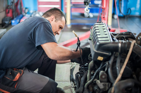 Removed engine from car. Car master auto mechanic repairer chacking and repair car engine in service...