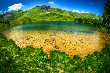 Panoramic view of beautiful mountain range with crystal clear turquoise lake. Pesica lake,...