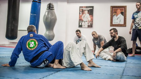 BELGRADE, SERBIA - 15. DECEMBER 2019. Sensei master instructor Avi Nardia explains BJJ Brazilian Jiu Jitsu ground fighting technique to his students on Kapap Krav Maga BJJ and KNIFE DEFENCE Seminarのeditorial素材
