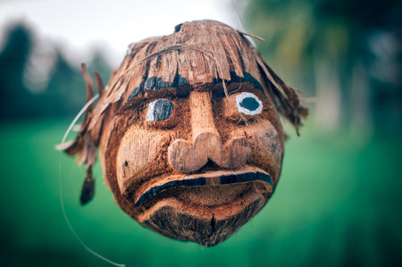 BALI, INDONESIA - 02. APRIL 2018. Coconut craft. Works of art made of coconut shells hanging in a cafe. Coconut head. Day editorial shotのeditorial素材