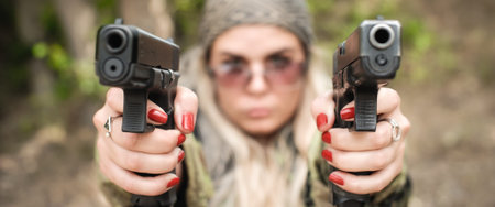 Attractive soldier woman practice shooting with two gun and gun point aim to attacker. Abstract...