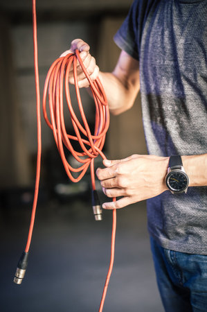 Behind the scene. Sound engineer is connecting the audio cables in the theater