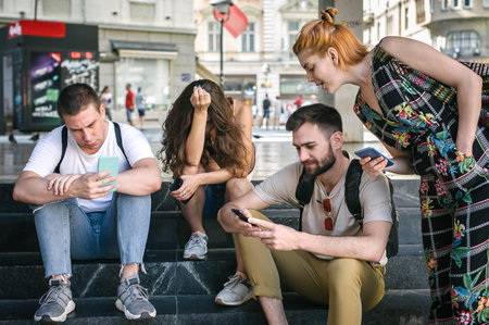Group of friends using smartphones together. Young people addiction to new technology trends. Youth,...