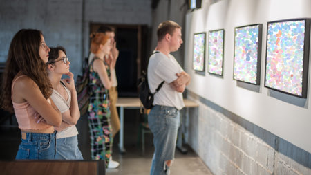 Group of friends in modern art exhibition gallery hall contemplating artwork. Abstract painting