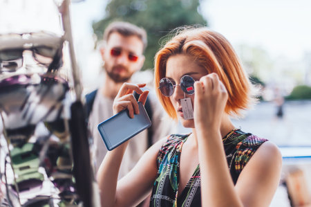 Customer woman choosing and buying sunglasses in optician shop outdoors, uv protection and fashion...