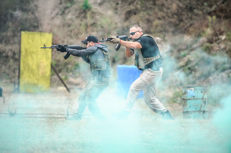 Military army soldiers in action tactical combat shooting from rifle machine gun. Shooting and...