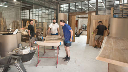 Team of carpenters making furniture in a workshop. Woodworking and crafts toolsの写真素材