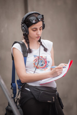 Behind the scene. Sound director technician with headset on his head writing sound and voice...
