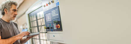 Field service maintenance engineer technician electrician inspect and control machine hardware and software system with laptop computer. Electric installationの写真素材