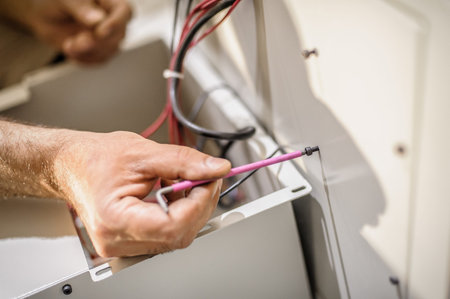 Close up of electrician engineer works with electric cable wires. Installation inspect. Electrical...