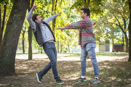 Man pushes another during quarrel. Two very angry, nervous and upset men in an aggressive and fierce...