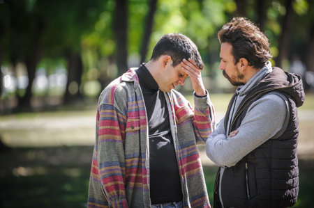 Young gay homosexual couple, men in quarrel conflict, argue dissatisfied and try to solve their...