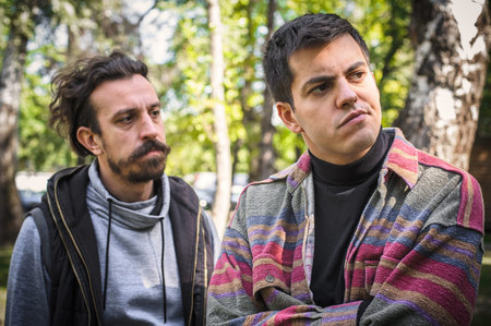 Young gay homosexual couple, men in quarrel conflict, argue dissatisfied and try to solve their...