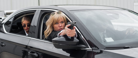 Professional armed team of female and male bodyguards shoot and protect a VIP celebrity person in...